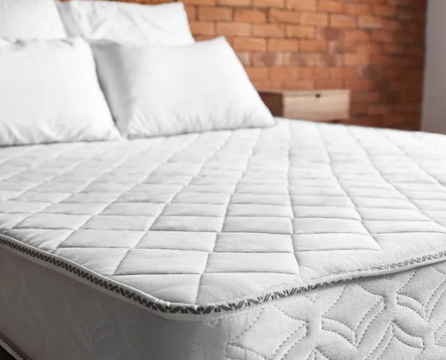 White quilted mattress on bed