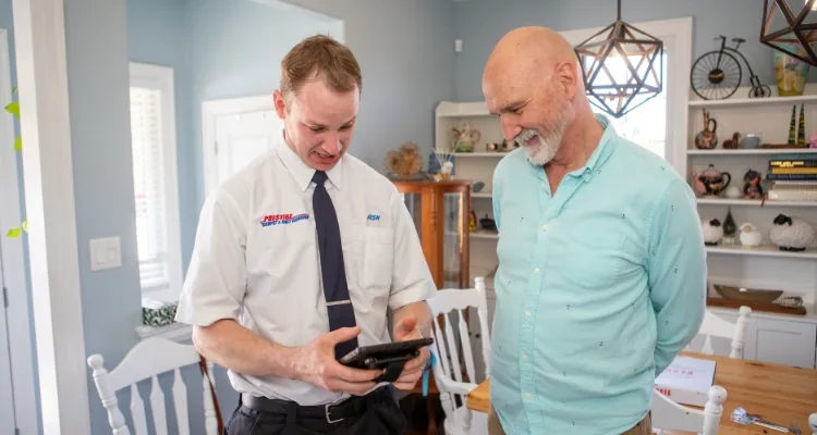 Prestige Carpet Cleaning Technician Josh Shows Home Owner His Bill